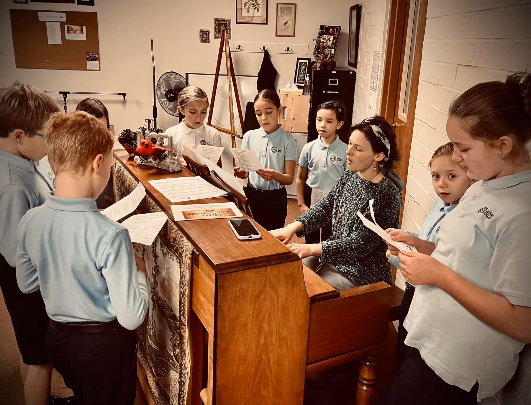 Geneva Academy grammar students singing hymns around the piano in Roseburg, Oregon