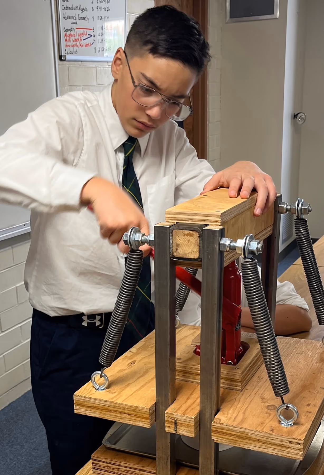 A Geneva Academy student building a hydraulic press in Roseburg, Oregon