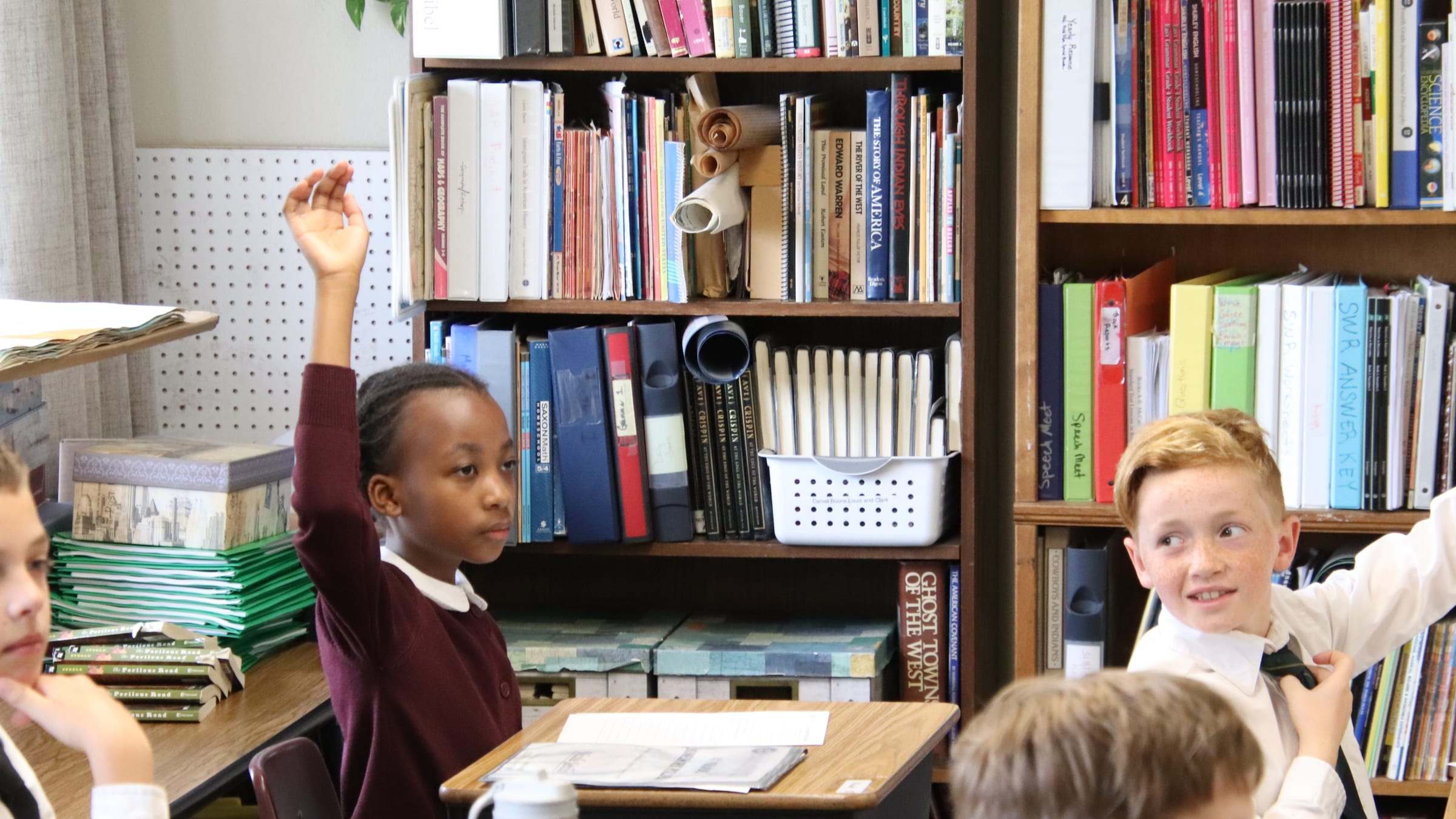 A Geneva Academy student raising her hand in class, Roseburg, Oregon